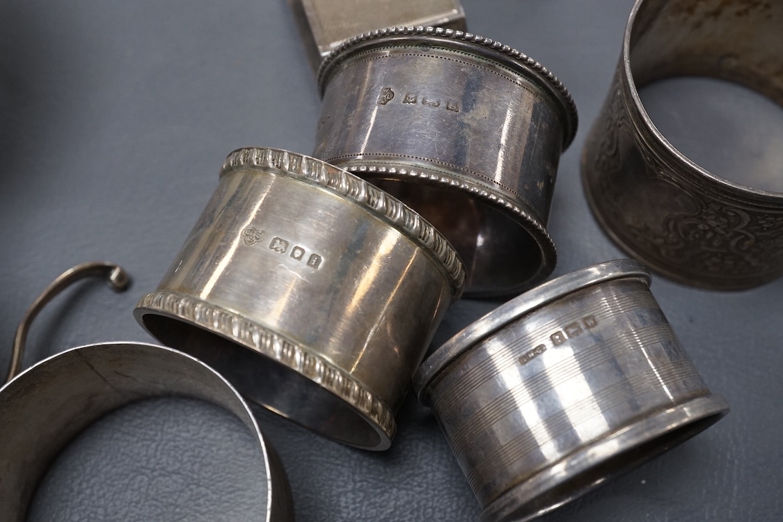 A pair of 19th century tripod salts, height 60mm, together with eight assorted silver napkin rings and a pair of small Victorian silver coasters?, 16.5oz.